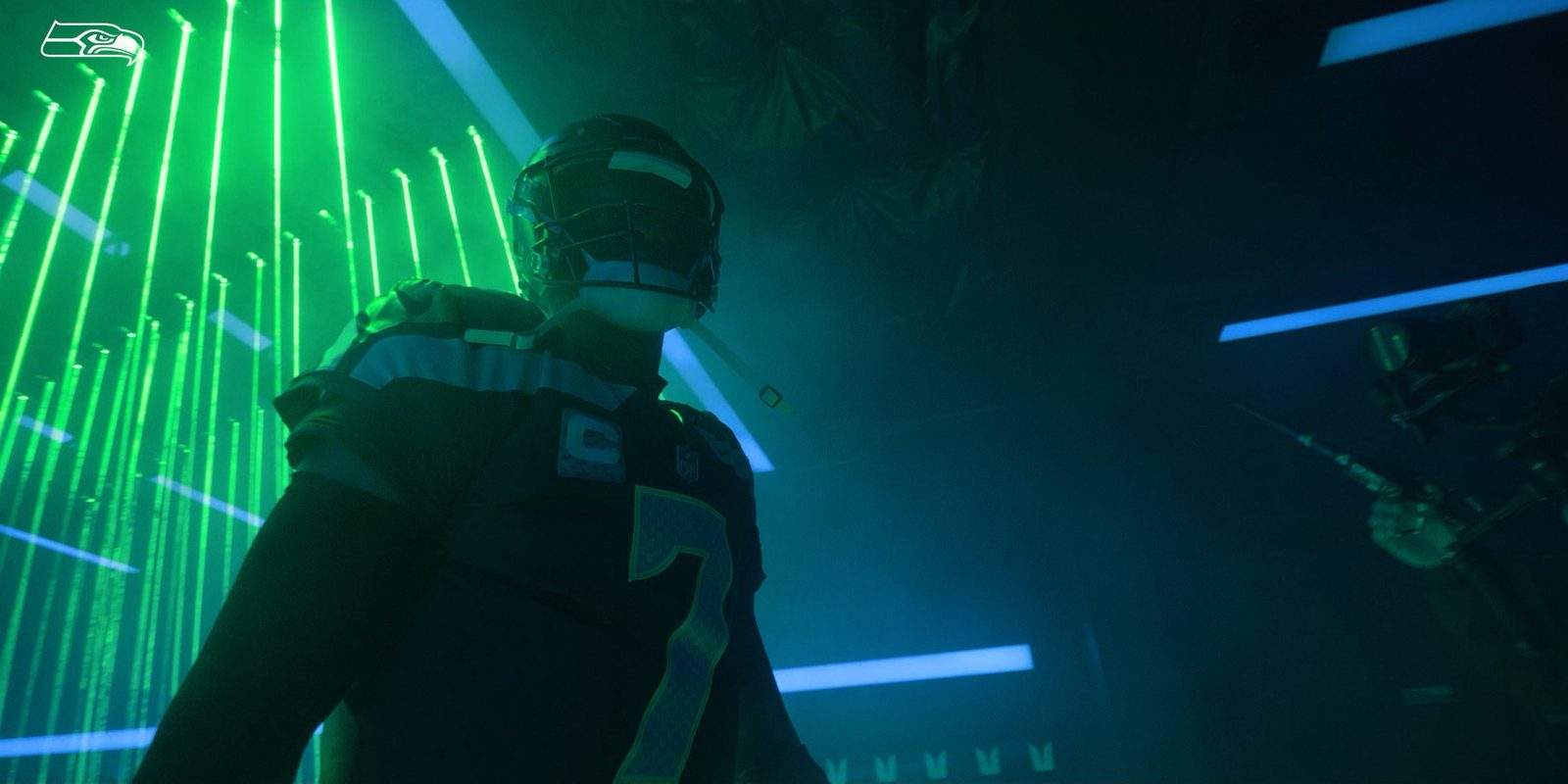 Still from The Sound, season two. A player in a helmet walks through a tunnel of green and blue light.